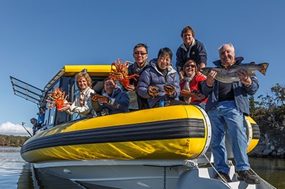 Guests on a seafood seduction cruise with the fresh catch of the day