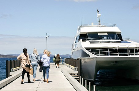 Guests admiring the stunning hobart scenery from the comfort of a luxurious catamaran