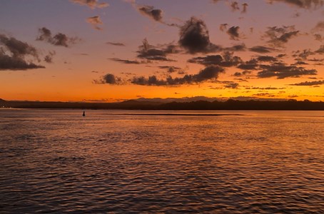 Guests enjoying the stunning Noosa sunset aboard the cruise